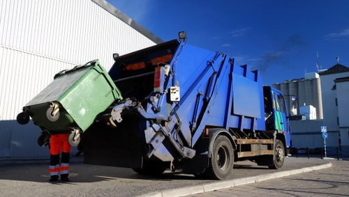 A professional team removing garden waste from a Plumstead garden.